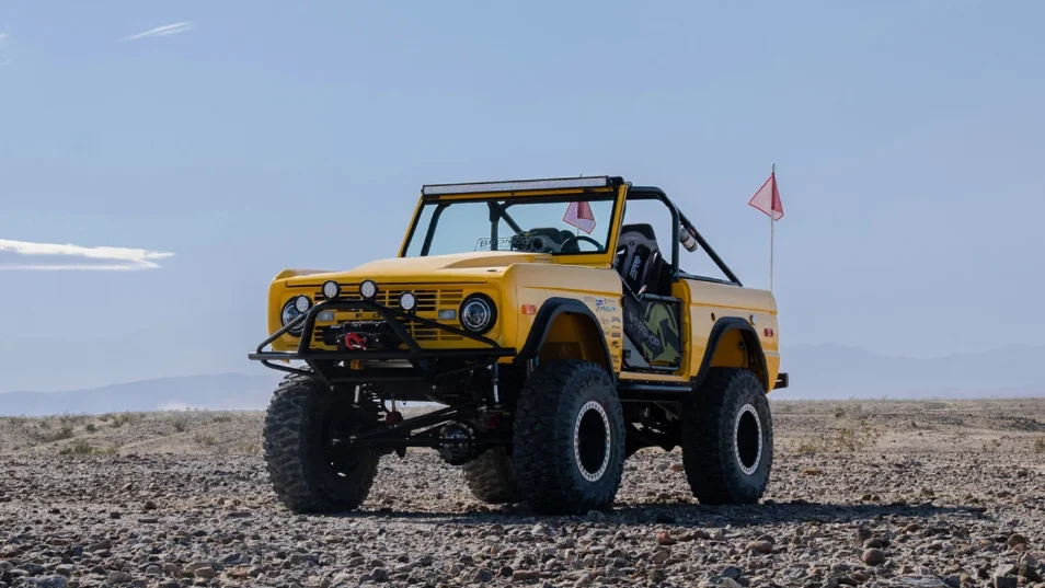 3/4 view of Dana Nevins Yellow 1970 Ford Bronco with King Shocks and Atturo Tires