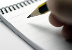 Desk with notebook and pen for drafting product descriptions